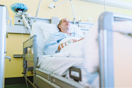 Male patient after injury or surgery in hospital wardの写真素材