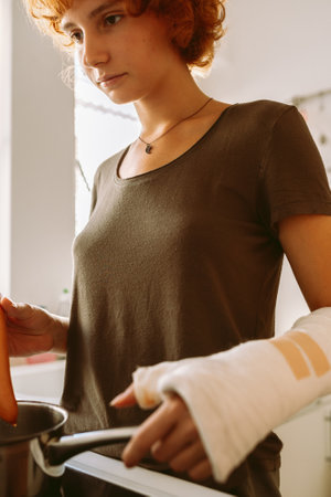 teenage girl, with cast on arm, cook lunch at home