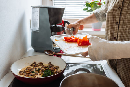 teenage girl, with cast on arm, cook lunch at homeの写真素材