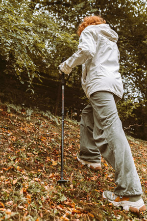 Nordic Walking in Autumn forest, hiking teenage girlの写真素材