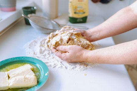 Female hands kneading dough