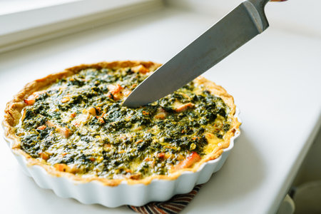 open spinach pie in baking dish