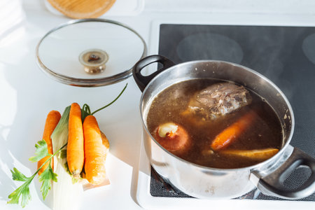 Cook meat broth with vegetables in your home kitchenの写真素材