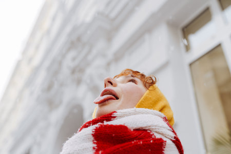 Positive portrait teenage girl in snowfall cityscape
