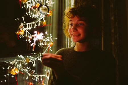 Close up smiling teenage girl with sparklersの写真素材