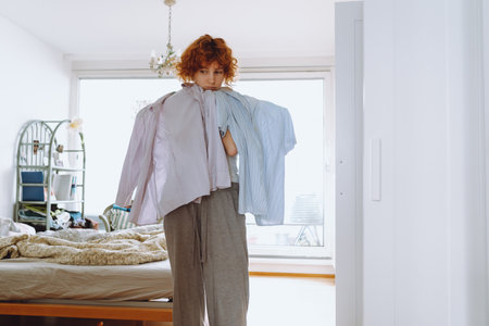 Teenager girl looking at clothes in wardrobeの写真素材