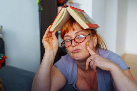 Portrait red-haired woman reading novel book