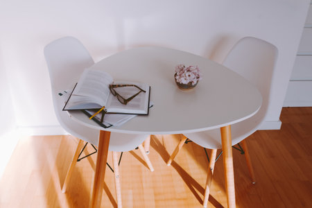 round table in interior with parquet floor and white wallの写真素材