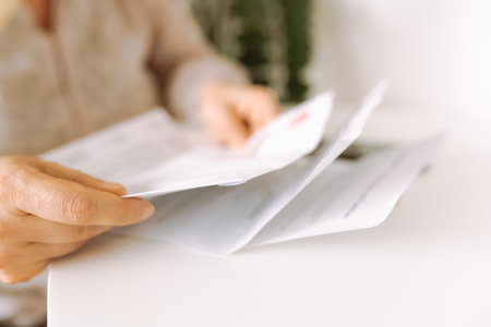 womans hands holding an envelope with a letterの写真素材