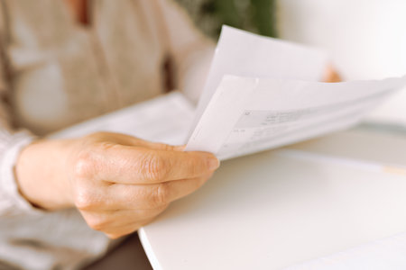 womans hands holding an envelope with a letterの写真素材