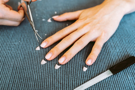 womens hands with manicure, one hand with trimmed nailsの写真素材