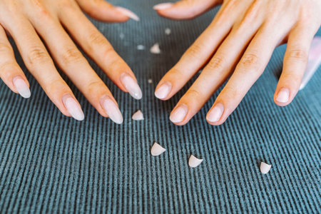 womens hands with manicure, one hand with trimmed nailsの写真素材