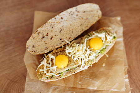 vegetable bruschetta with quail eggs, cheese in a home kitchenの写真素材
