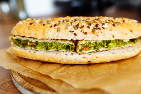 sandwich on whole grain bun with vegetable pattyの写真素材