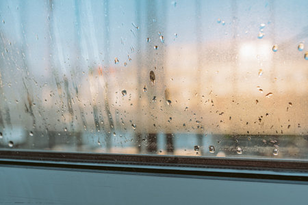 water droplets running on a double glazed window