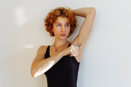 young woman uses hygiene product, roll-on deodorantの写真素材