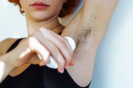 young woman uses hygiene product, roll-on deodorantの写真素材