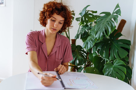 homeschooling, woman writing notes in notebookの写真素材