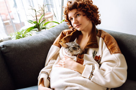 portrait young woman hugging gray fluffy domestic catの写真素材