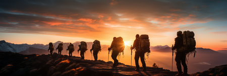 fellow travelers, conquering mountains as friends, reaching new heights at sunset in mountainsの素材