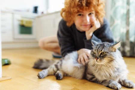 young woman hugging pet domesticated catの写真素材