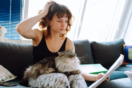 young woman spending time with her catの写真素材