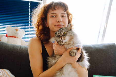 young woman spending time with her catの写真素材
