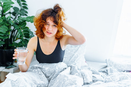morning headache woman hangoverの写真素材