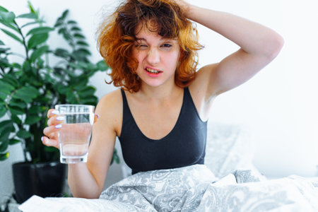 morning headache woman hangoverの写真素材