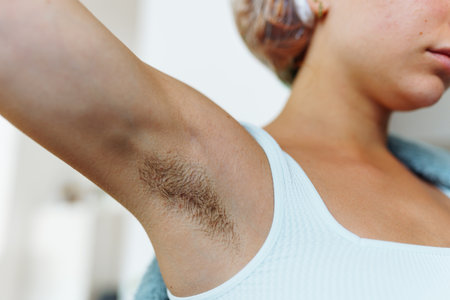 an unrecognizable young woman with unshaven armpitsの写真素材