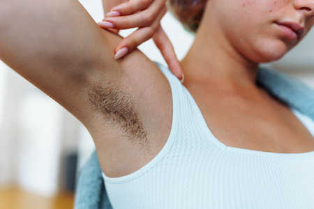 an unrecognizable young woman with unshaven armpitsの写真素材