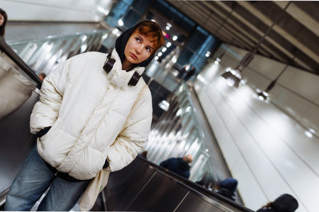 young woman in white winter jacket in the underground metro