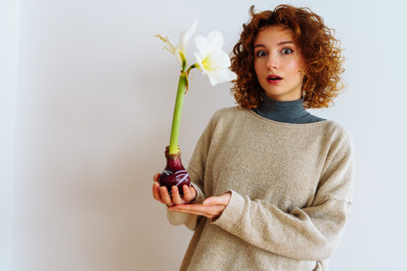 young woman with an amaryllis flower