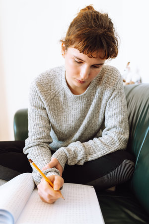 young woman writing notebook