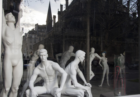 Paris, France - April 15, 2013: Showcase a sports shop. Mannequins. In the glass reflected the evening street.のeditorial素材