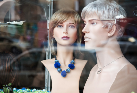 mannequin head wearing a wig and a necklace