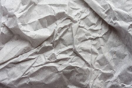 Crumpled gray wrapping paper as background.