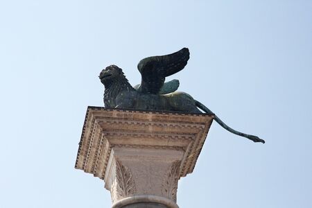The winged lion is a symbol of Venice against the blue sky. Venice, Italy.の写真素材