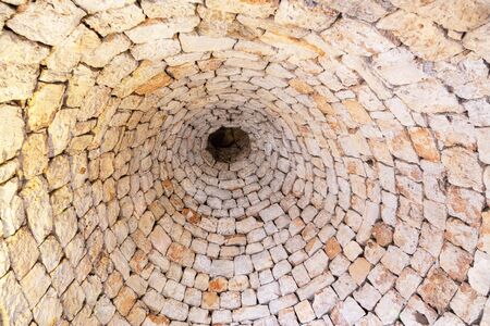 Typical conical stone roof of a house - trullo in Alberobello, Puglia, Italy. View from the bottom up, indoors.の写真素材
