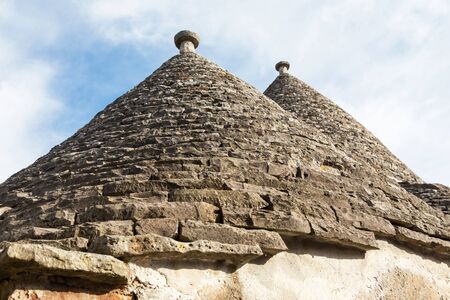 Typical conical stone roof of a house - trullo in Alberobello, Puglia, Italy.の写真素材