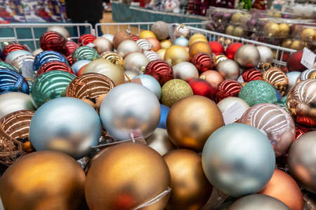 Many multi-colored Christmas balls, as a New Year's festive background. Pre-Christmas trade in bright Christmas tree decorations.の写真素材