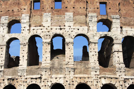 Arches of the ancient Coliseum (Colosseum) close-up, fragment. Rome, Italy.