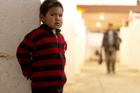 SUCRE, BOLIVIA - JANUARY 18, 2012  A boy play hide and seek inside the popular market  January 18, 2012 in Sucre, Bolivia のeditorial素材