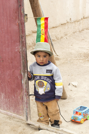 UYUNI, BOLIVIA - JANUARY 21, 2012  A little boy plays with his toy car in a desert town  January 21, 2012 in Uyuni, Bolivia のeditorial素材