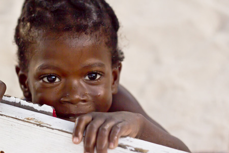 SAN PEDRO, BELIZE - SEPTEMBER 24, 2013  A Belizean kid plays by the famous beach of San Pedro  September 24, 2013 in San Pedro, Belizeのeditorial素材
