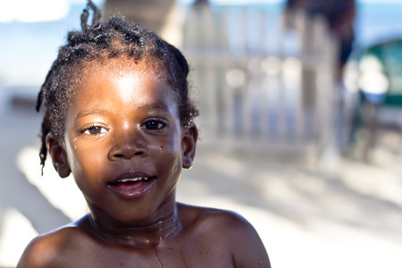 SAN PEDRO, BELIZE - SEPTEMBER 24, 2013  A Belizean kid plays by the famous beach of San Pedro  September 24, 2013 in San Pedro, Belizeのeditorial素材