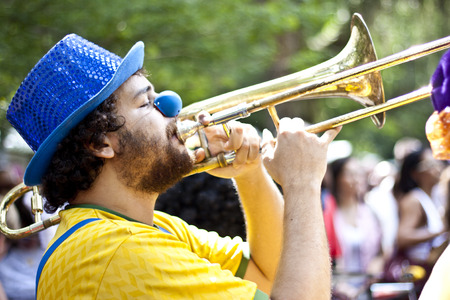 NITEROI, BRAZIL - MAY 6, 2012: People in costumes playing instruments while taking part in a Carnival-like parade, celebrating the anniversary of a local street band. May 6, 2012 in Niteroi, Brazilのeditorial素材