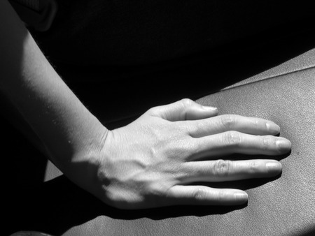 Road Trip. A hand on a back seat under the sun.の写真素材