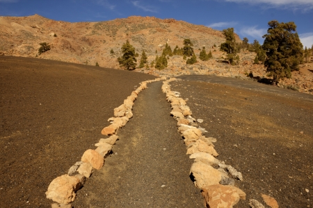 road marked with stones in volcanic soilの写真素材