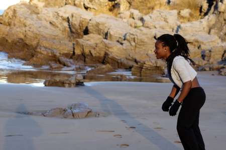 black woman ready to run by the beachの写真素材
